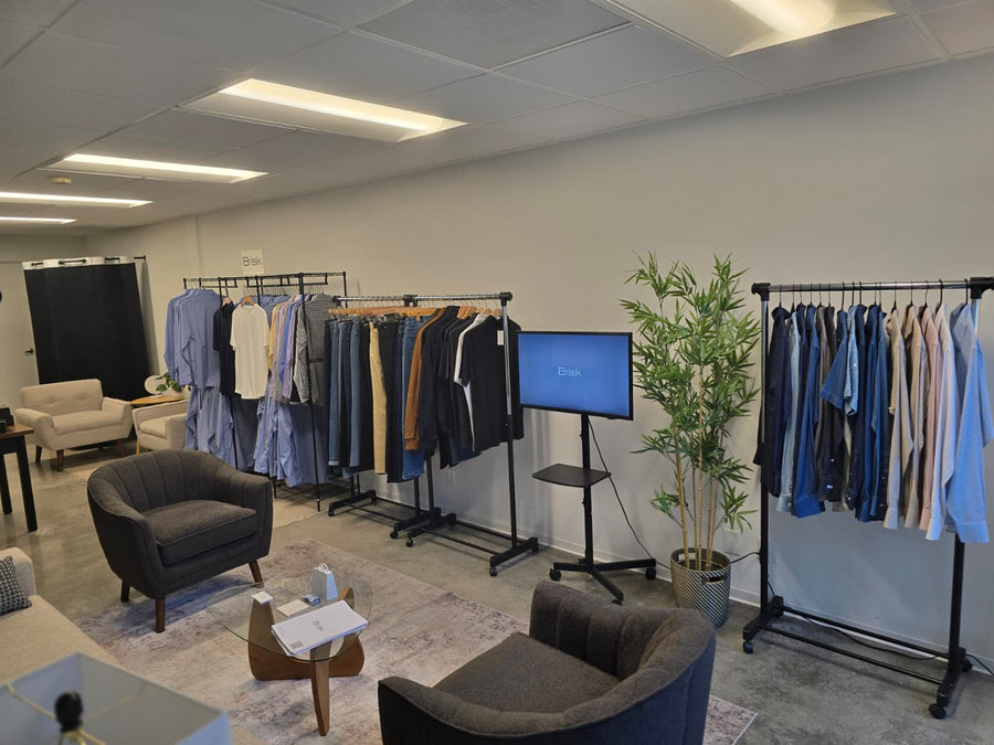 Inside the Brisk showroom: racks of shirts beside a sofa and armchairs